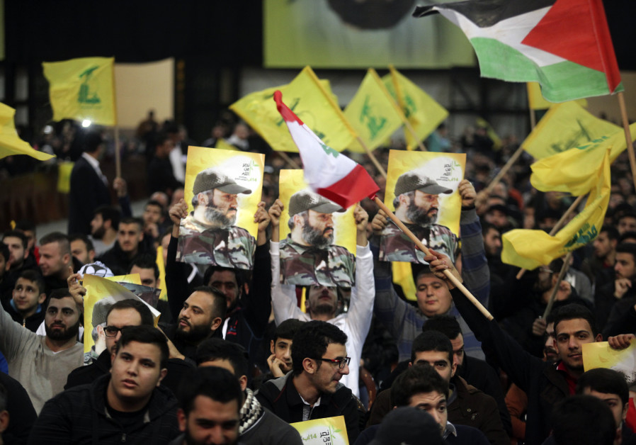 Supporters of Lebanon's Hezbollah leader Sayyed Hassan Nasrallah carry pictures of Hezbollah's late 