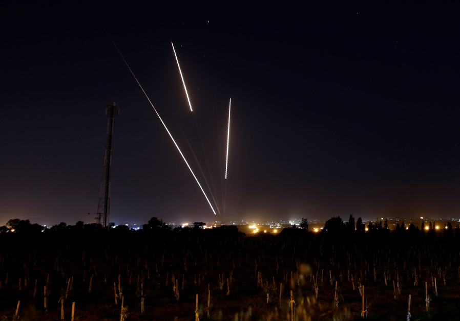 Streaks of light are pictured as rockets are launched from the Gaza Strip towards Israel, as seen fr