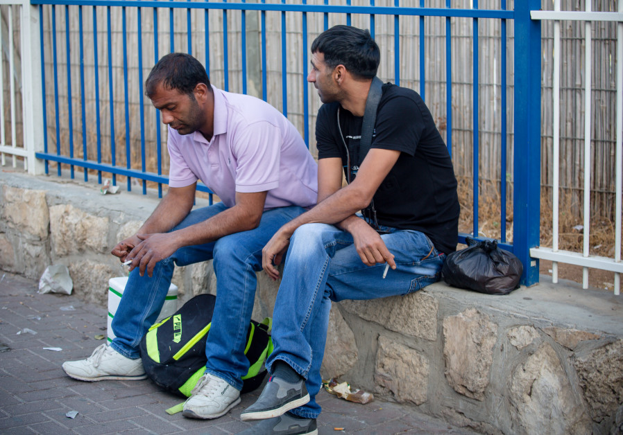 Palestinians rest for a moment at Checkpoint 300 (Courtesy of Laura Ben-David)