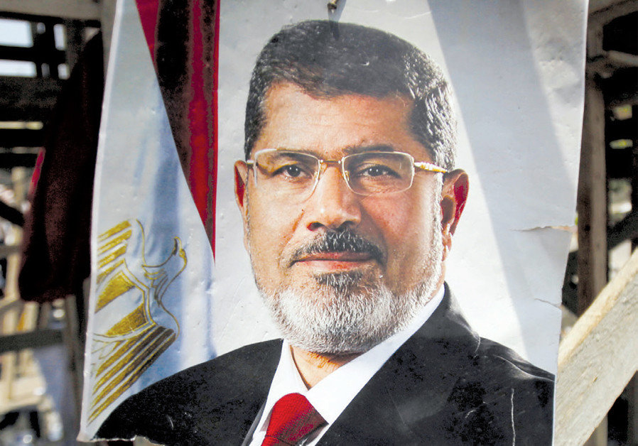 A POSTER of then-Egyptian president Mohamed Mursi reading ‘No substitute for the legitimacy’ is seen after night clashes with anti-Mursi forces in Giza, on the outskirts of Cairo, on July 3, 2013. (Credit: Reuters)