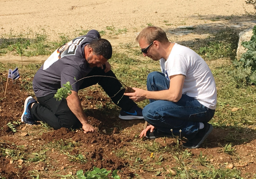 A Heroes to Heroes team planting trees at The Harvey Hertz-JNF Ceremonial Tree Planting Center at Neot Kedumim. (photo credit: Courtesy)