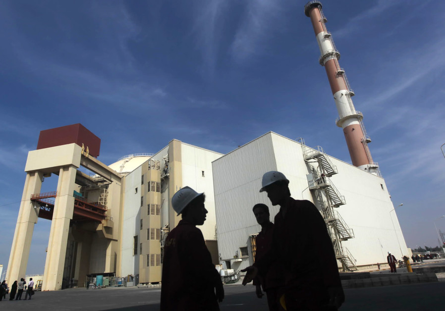 Iranian workers stand in front of Bushehr nuclear power plant, 1,200 km south of Tehran