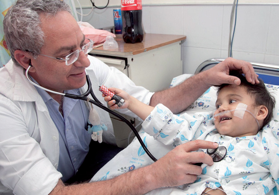 Dr. Lior Sasson with a child from Romania (Credit: SACH)