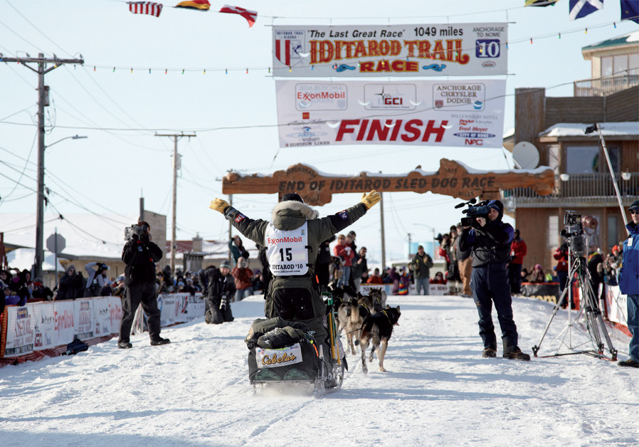 Crossing the finish line of the Iditarod dog sled race (Credit: CHRIS CLENNAN / STATE OF ALASKA)