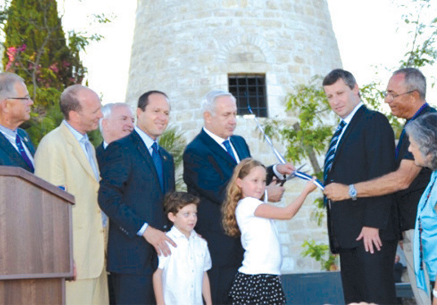 PRIME MINISTER Benjamin Netanyahu reopens the windmill in 2012, with (fourth from left) mayor Nir Barkat, the writer and brother Simon Sebag Montefiore looking on. (Credit: Sharon Altshul)