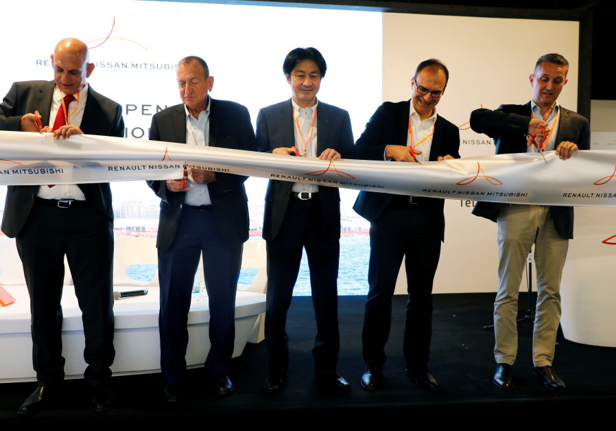  Tsuyoshi Yamaguchi, stands next to Tel Aviv mayor Ron Huldai and other officials as they cut a ribbon during the inauguration of Renault-Nissan-Mitsubishi's joint innovation lab in Tel Aviv, Israel. (Amir Cohen/Reuters)