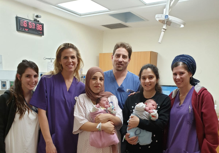 Marlin Jamal Majat (L) holding her newborn daughter and Tali Sasson (R) holding her newborn son