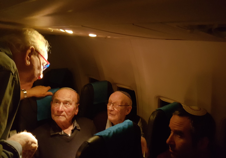Survivors share their stories of the Holocaust during a flight to Poland on Saturday night. (Credit: Ilanit Chernick