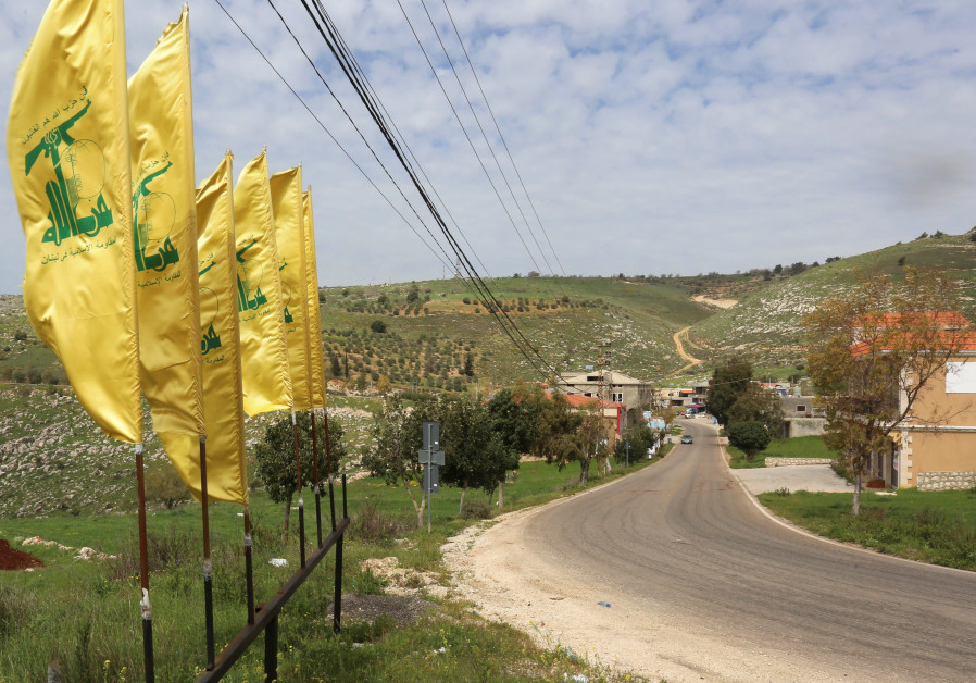 HEZBOLLAH FLAGS flutter along an empty street, at the entrance of Mays Al-Jabal village (Photo Credit: Seth J. Frantzman)