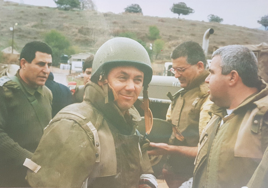 THE WRITER, clad in helmet and flak vest, at the Egel Gate gets ready to embark on a visit to the security zone in 1998 (Photo Credit: Courtesy)