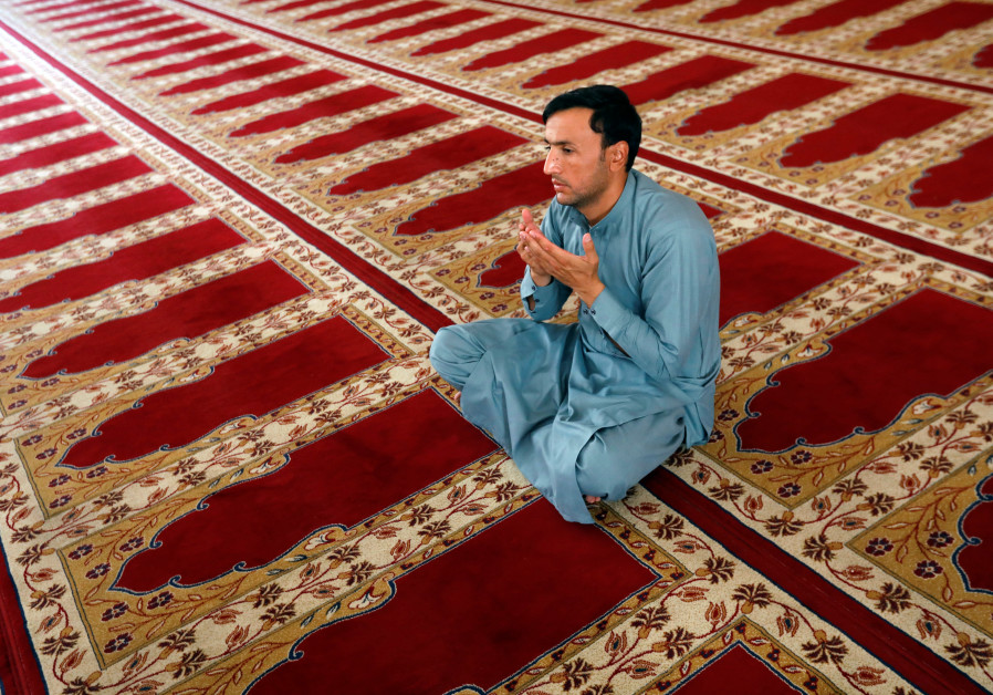 An Afghan man prays during the Muslim festival of Eid al-Adha, amid the spread of the coronavirus disease (COVID-19), in Kabul, Afghanistan July 31, 2020. (Credit:REUTERS/Mohammad Ismail)