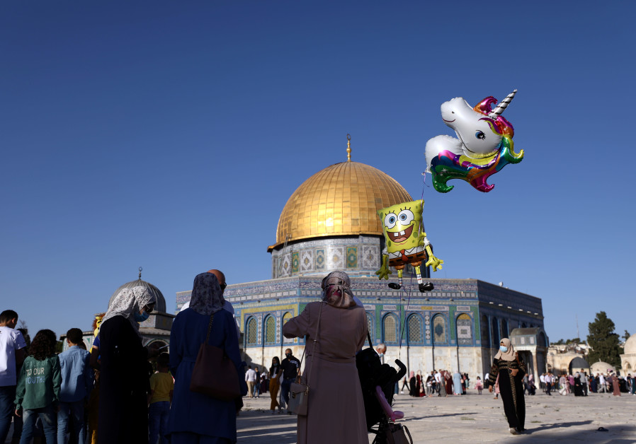 A girl poses for a photo during celebrations for the Muslim holiday of Eid al-Adha on the compound known to Muslims as Noble Sanctuary and to Jews as Temple Mount in Jerusalem's Old City amid the coronavirus disease (COVID-19) outbreak in Jerusalem July 31, 2020 (Credit: Reuters/Ammar Awad)