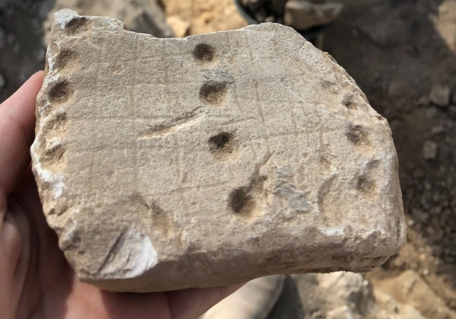 Another game found at the site was called “Hounds and Jackals,” or “58 Holes" (Credit: Emil Aladjem/Israel Antiquities Authority)
