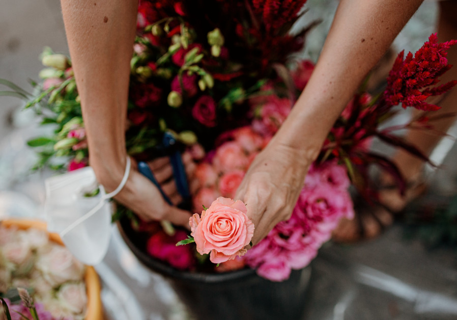 Flowers are a godly gift, and we put our own expression in it, said Jerusalem-based florist Sara Winter on Tu Be'av in Jerusalem (Credit: Tzipira Lifchitz)
