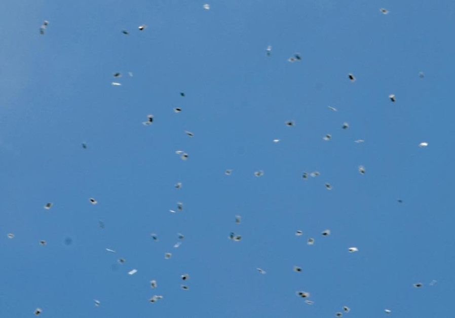 A drone drops hundreds of bags of cannabis in the skies of Tel Aviv. (Credit: AVSHALOM SASSONI)