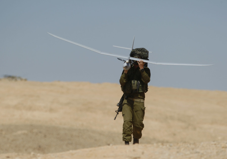 A SOLDIER carries a drone during an IDF military exercise at the Shizafon base, north of the southern city of Eilat. (Amir Cohen/Reuters)