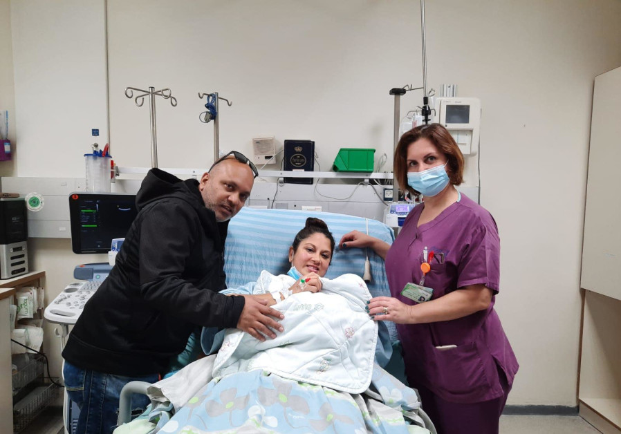Nurit and Oren Falker, their 2021 newborn and their midwife (Credit: Kaplan Medical Center)