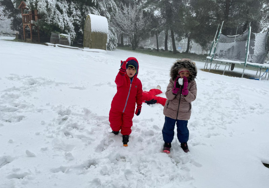 Liner Family children enjoy the snowy morning in Kibbutz Ein Zivan