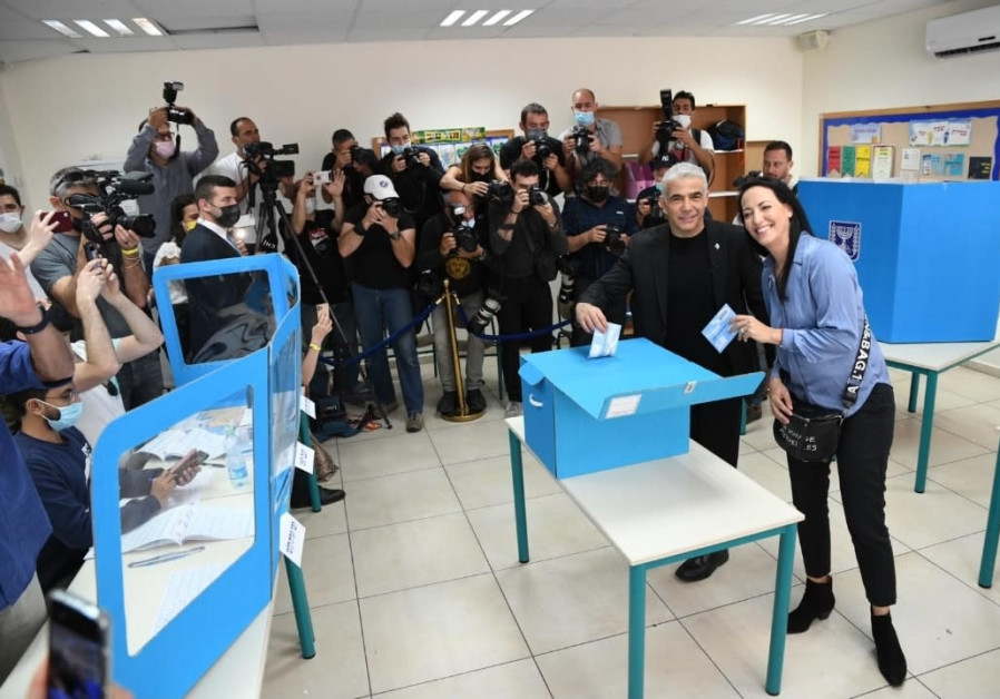 Yair and Lihi Lapid vote in Tel Aviv (Photo Credit: Courtesy)