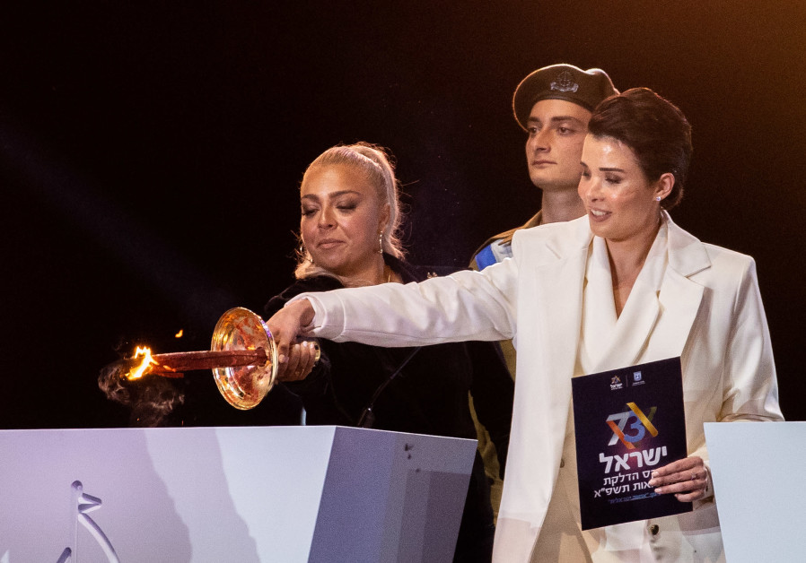Shira Isakov and Adi Guzi light a torch during the 73rd anniversary Independence Day ceremony, held at Mount Herzl, Jerusalem on April 14, 2021 (photo credit: Yonatan Sindel/ Flash 90).