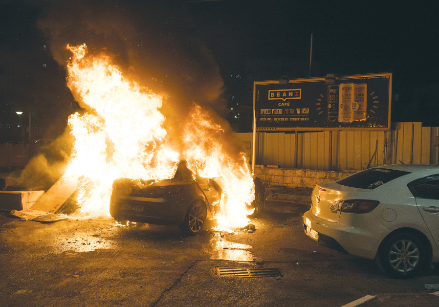 A CAR BURNS during clashes between Arabs and Jews in Acre on May 12. (RONI OFER/FLASH90)
