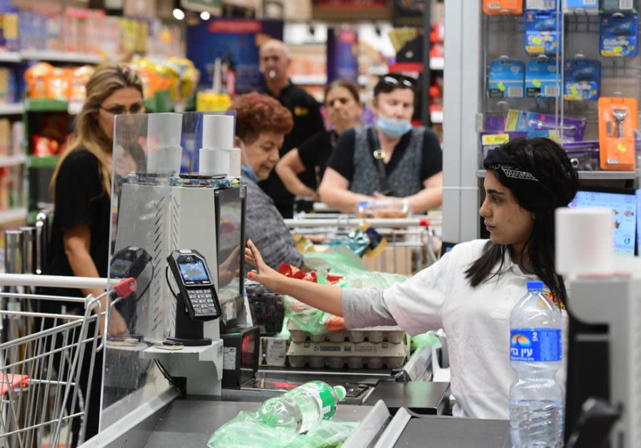 Supermarket shoppers and workers without masks in Tel Aviv. (photo credit: AVSHALOM SASSONI)