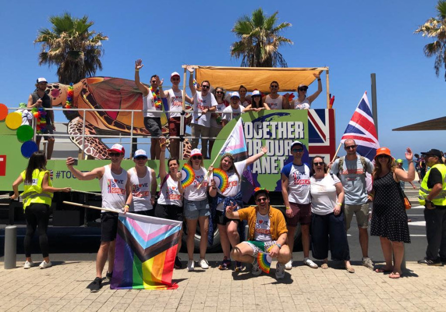 Staff of British Embassy in Israel pose in front of their environmental float ahead of the Tel Aviv Pride parade. (Credit: Embassy of the United Kingdom in Israel)