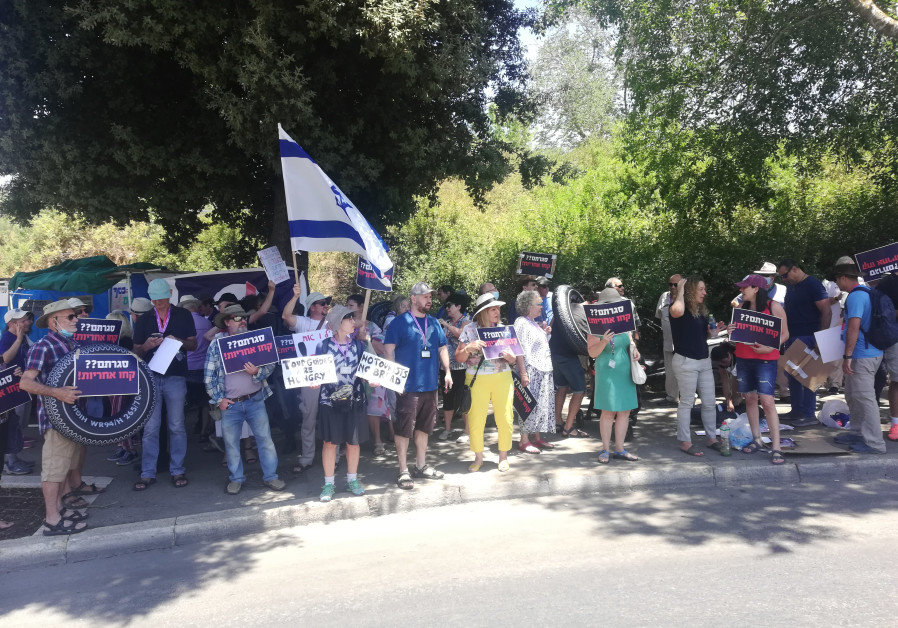 Israeli tour guides are seen protesting outside the Knesset as low tourism and no government benefits puts them in crisis, on July 6, 2021. (Credit: ZEV STUB)