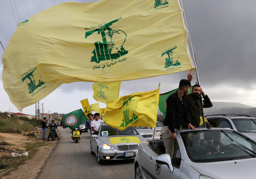 WAVING THE Hezbollah flag in Marjayoun, Lebanon. (Credit: AZIZ TAHER/REUTERS)