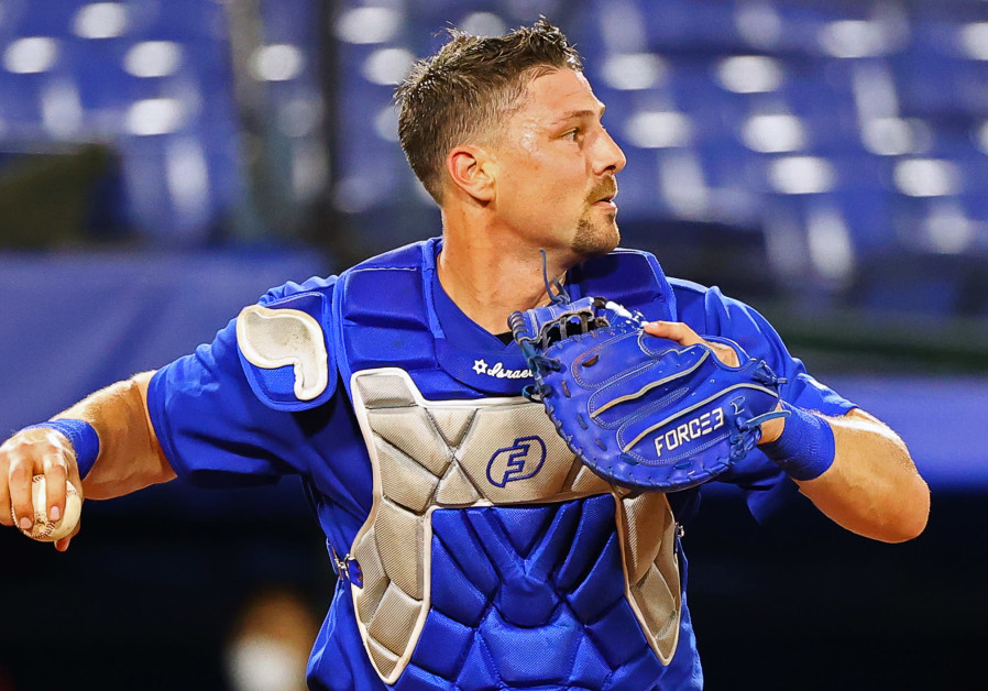 Israel's catcher Ryan Lavarnay with the Hebrew word "Chai" on his chest protector, hoping to keep Israel alive with his offense and defense. (Credit: Reuters/Jorge Silva)