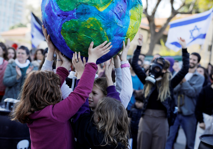 Children hold a globe during a demonstration against Israel's offshore Leviathan natural gas field due to environmental concerns. (Credit: REUTERS/NIR ELIAS)