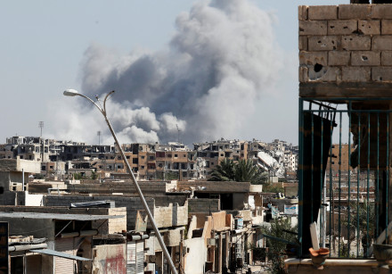 Smoke rises near the stadium where the Islamic State militants are holed up after an air strike by c