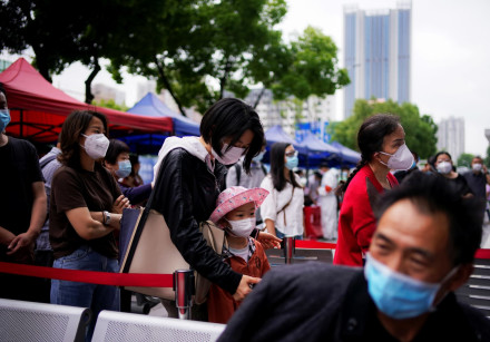 Residents wearing face masks queue for nucleic acid testings in Wuhan, the Chinese city hit hardest 