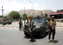 Afghan security forces keep watch at the site of a suicide attack in Kabul, Afghanistan June 4, 2018