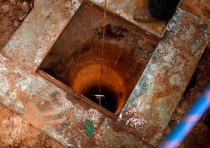 An Israeli soldier lowers a camera down an Israeli-dug hole into a cross-border tunnel dug from Leba