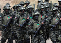 Palestinian Hamas militants take part in a rally marking the 31st anniversary of Hamas' founding, in