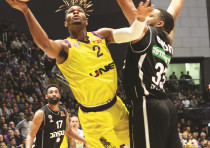 HAPOEL HOLON guard Corey Walden (2) goes to the hoop past Hapoel Jerusalem defender TaShaun Thomas