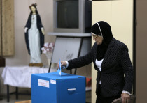 An Israeli Arab casts her ballot at a polling station in the northern town of Reineh, in 2015