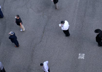 Jewish men gather for a socially distanced service at a basketball court on New York City's Lower East Side, June 24, 2020