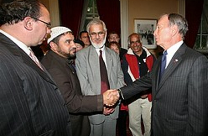 New York City Mayor Michael Bloomberg, right, gree (photo credit: AP)