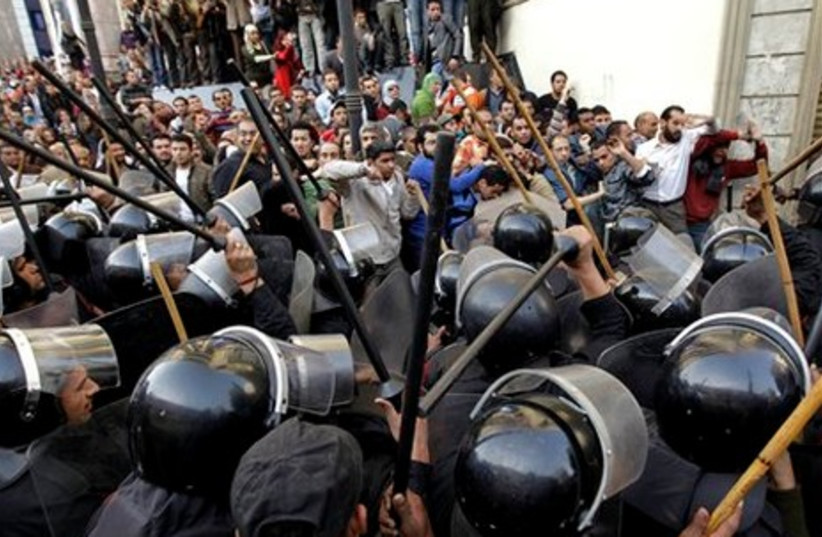 Angry protestor shouts at police in Cairo (AP)