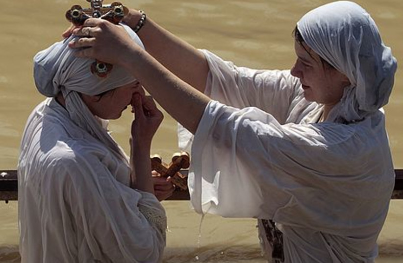 Nuns perform baptism in the Jordan River