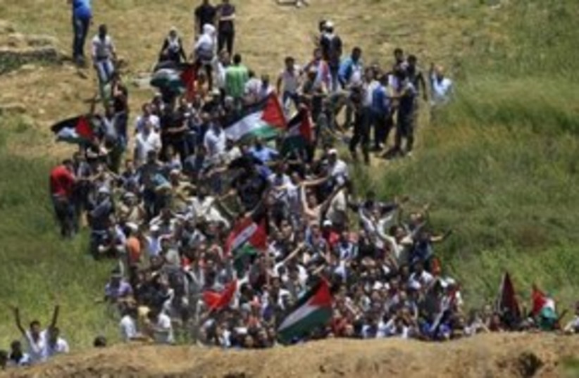 Syrian protesters approach the Israeli border 311 (R) (photo credit: REUTERS/Ronen Zvulun)