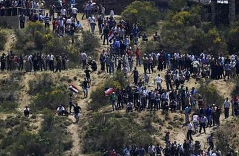 Palestinians protest on the Syrian-Israeli border.