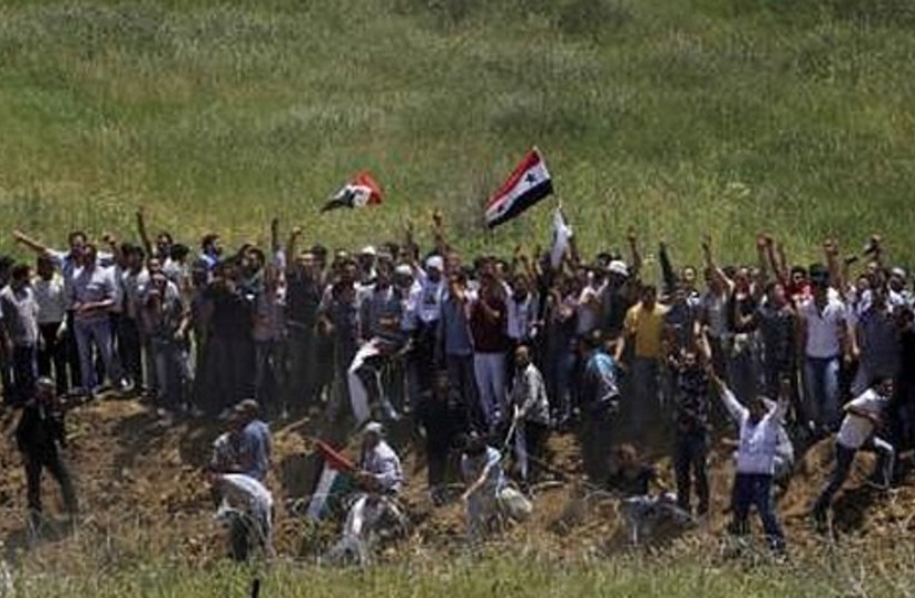 Palestinians protest on the Syrian-Israeli border.