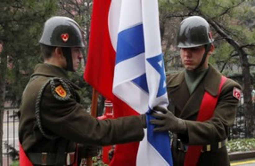 Turkish honor guard passes Israeli and Turkish flags 58 (R) (photo credit: REUTERS)