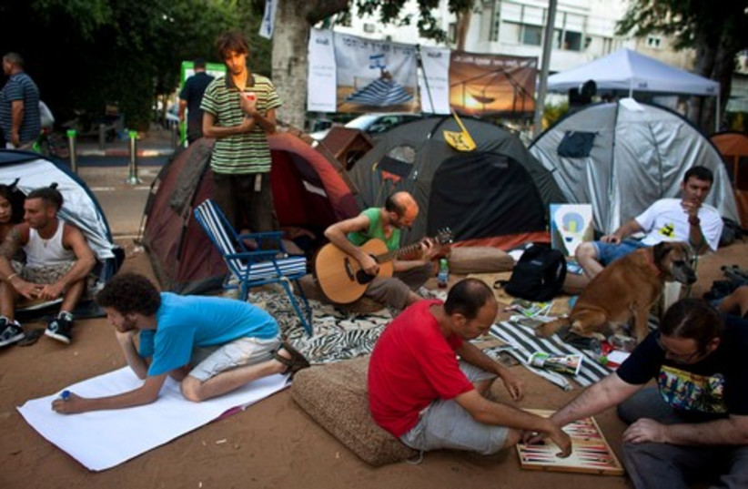 Protesters sit outside tents in Tel Aviv 521 (R) (photo credit: REUTERS/Nir Elias)