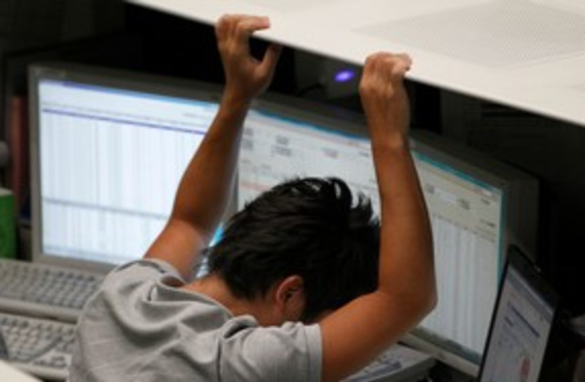 Tokyo Stock Exchange employee reacts to fall 311 (R) (photo credit: REUTERS/Kim Kyung-Hoon)