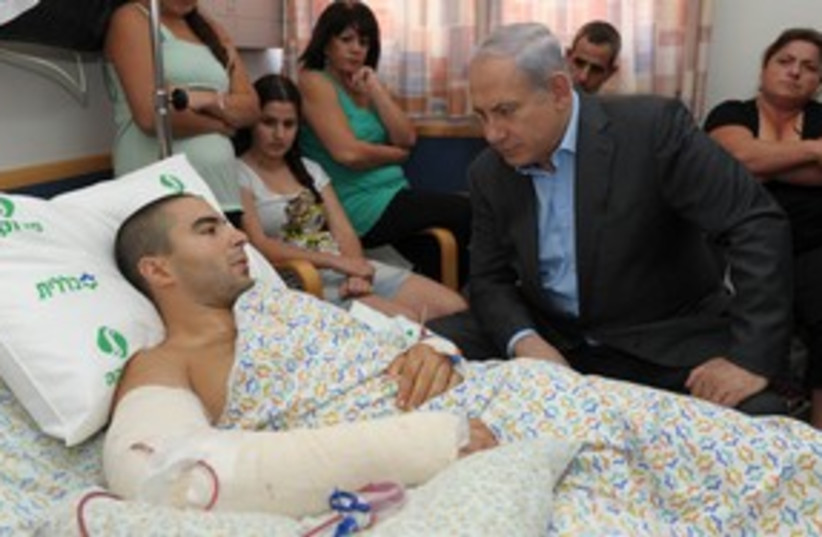 Netanyahu visits wounded soldier in hospital 311 (photo credit: Moshe Milnr / GPO)