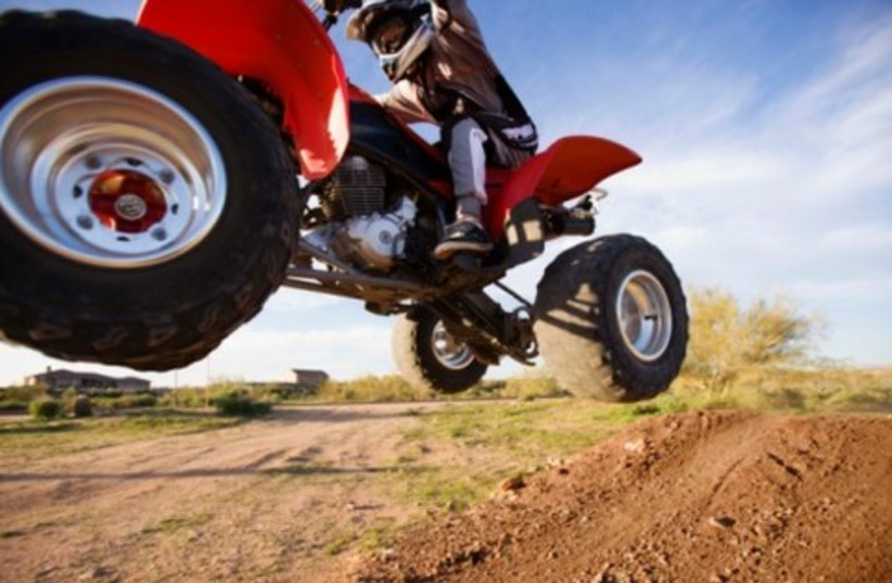 Youth riding ATV all terrain vehicle 521 (photo credit: Thinkstock/Imagebank)